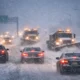 New Jersey Blizzard Warning: Vehicles and snowplows navigate a heavily snow-covered highway during a statewide blizzard warning.